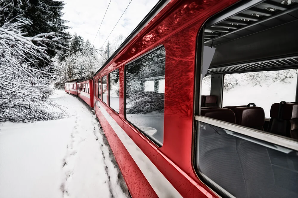 Red train in a winter mountain landscape as an application for DC/DC converters